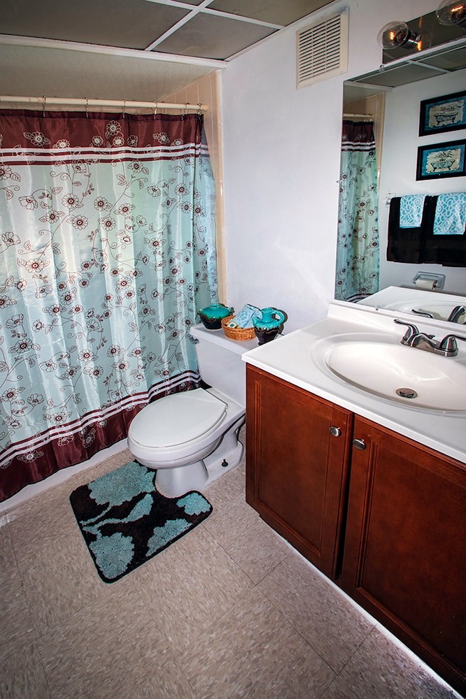 a bathroom with a toilet and a sink and a shower