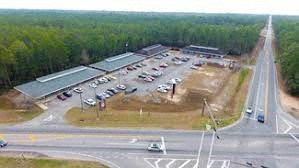 an aerial view of a parking lot with cars