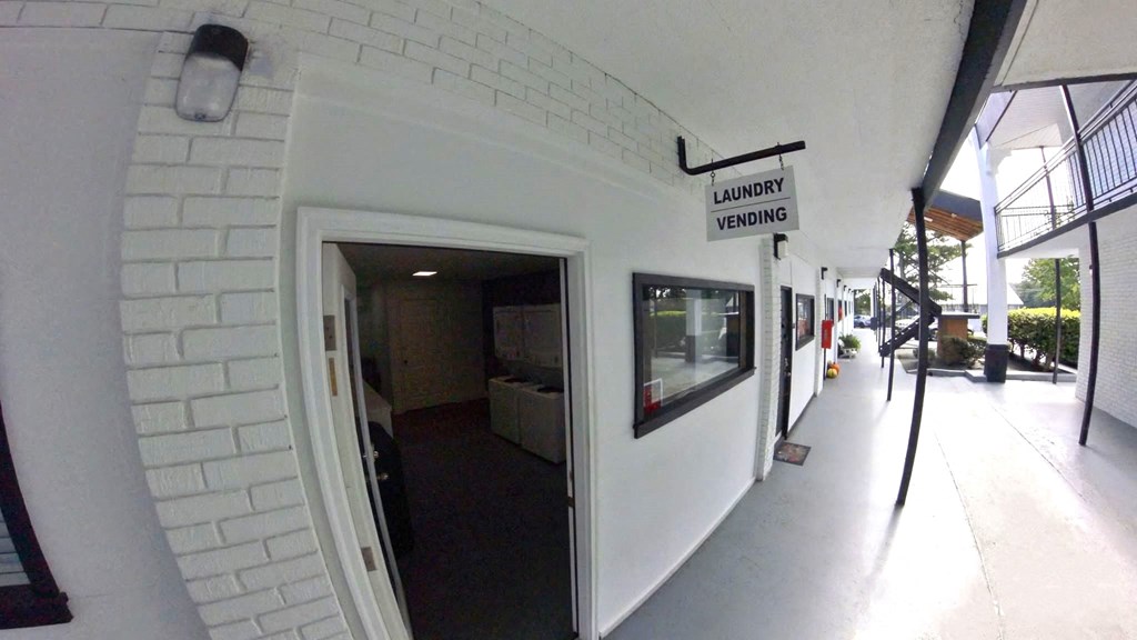 a white brick wall with an open door