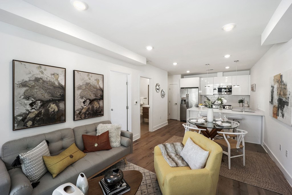 a living room with a couch and a table and a kitchen