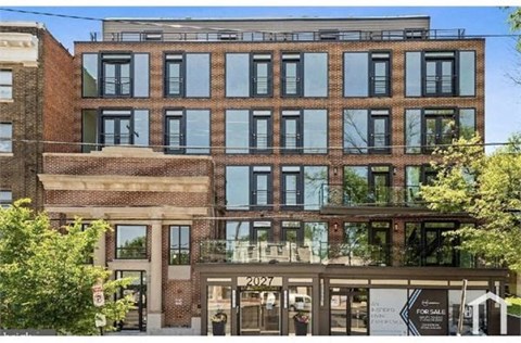 the facade of a brick building with glass windows