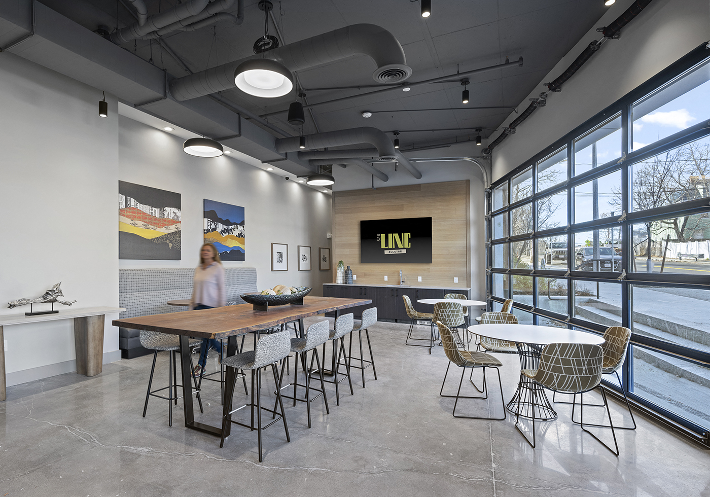 a dining room with tables and chairs and a large window