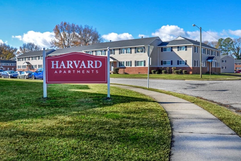 a apartments sign on the side of a sidewalk
