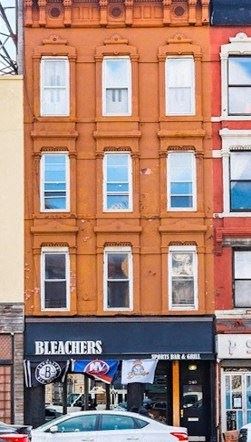 a building with a store and a car in front of it
