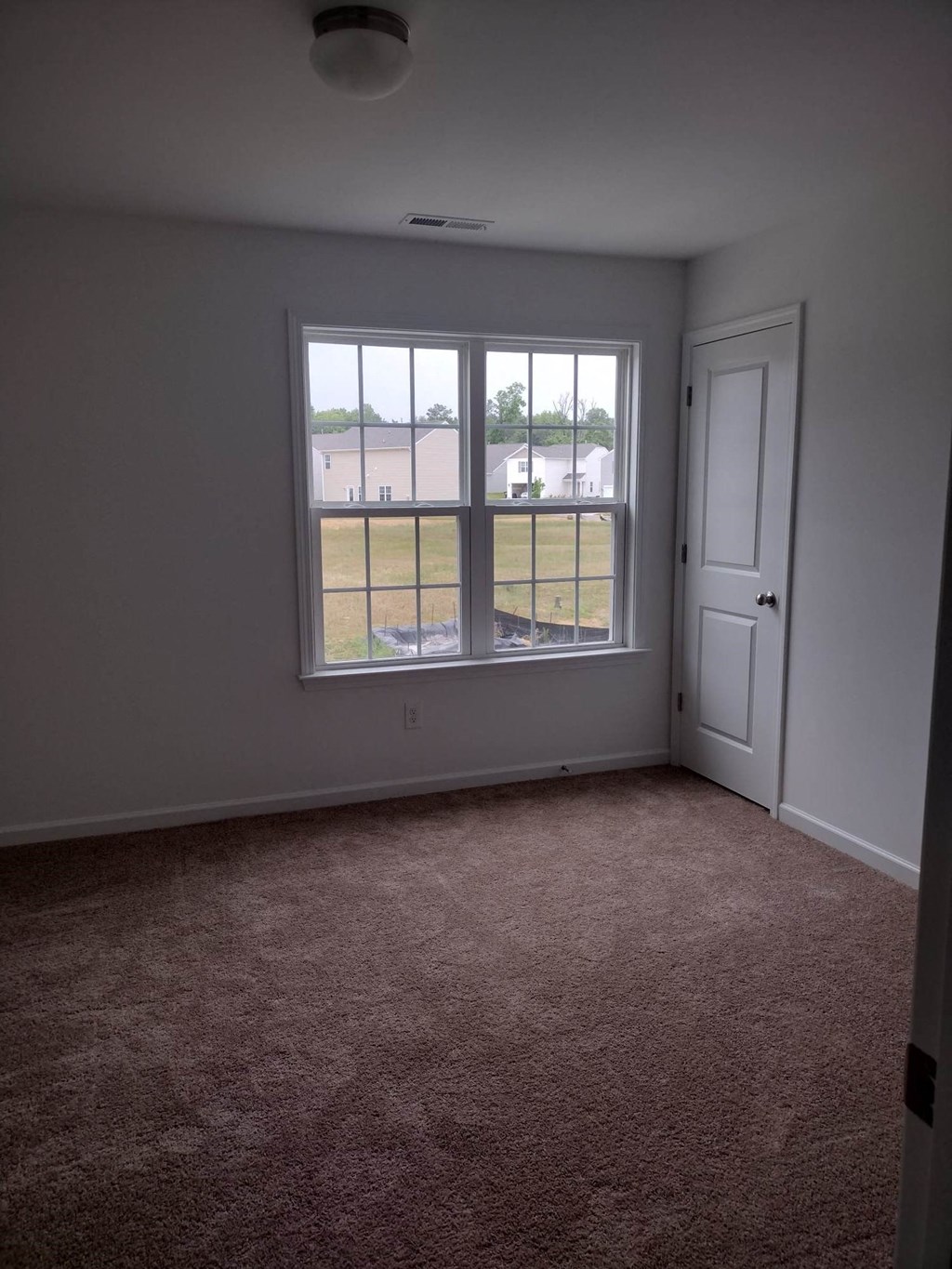 a living room with a window and a door