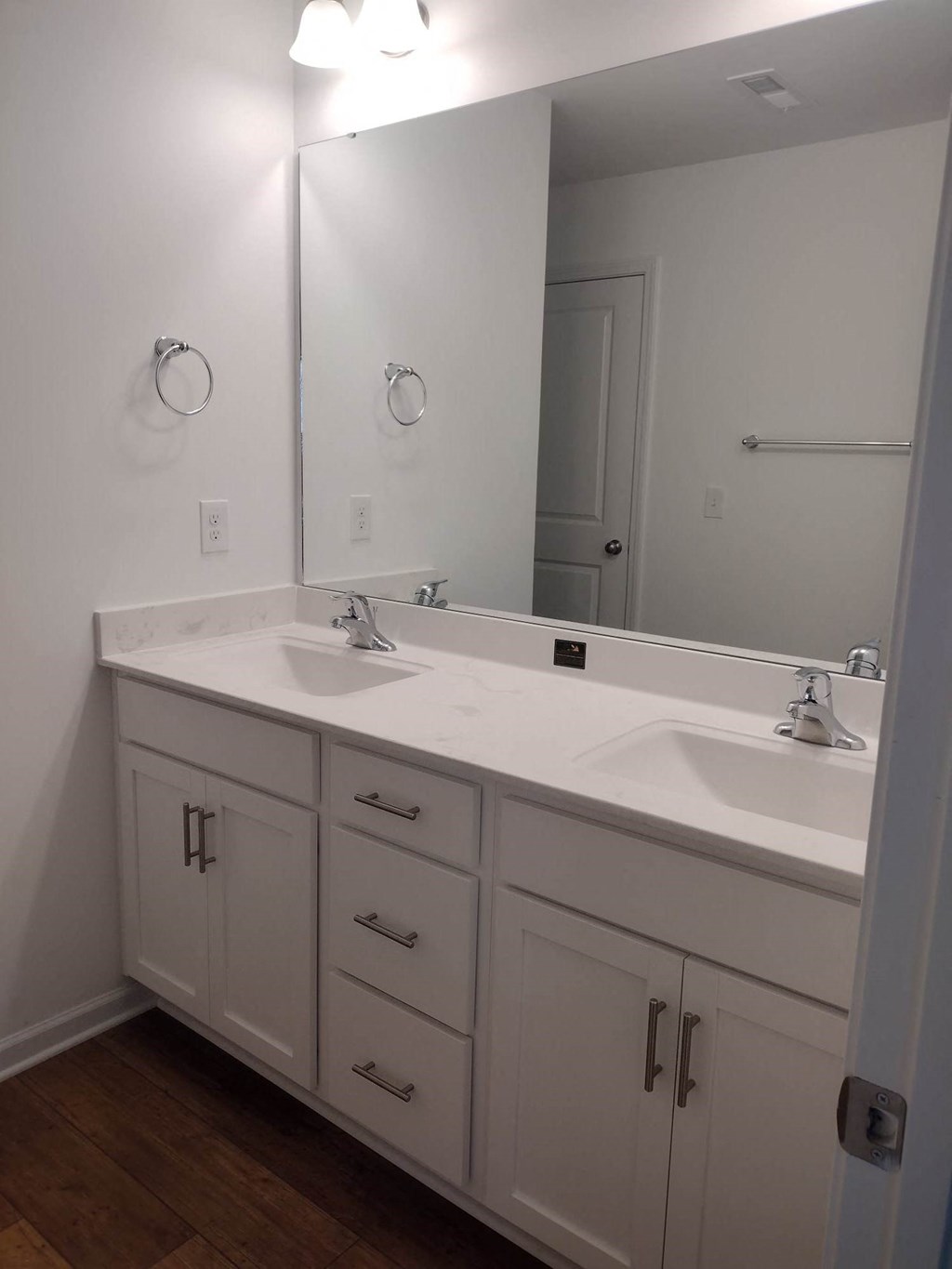 a bathroom with two sinks and a large mirror