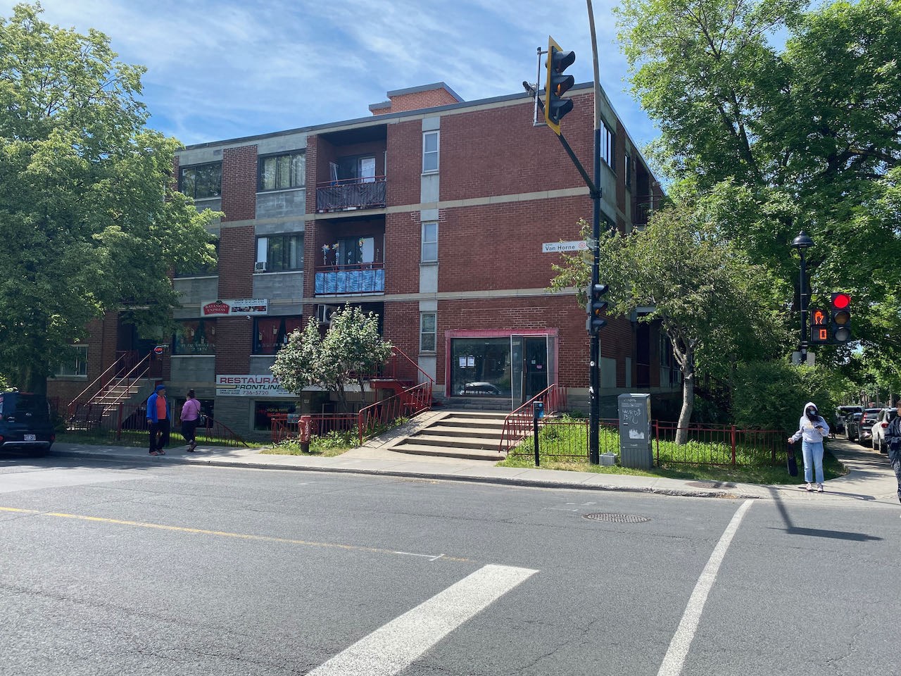 a red brick building on the corner of a street