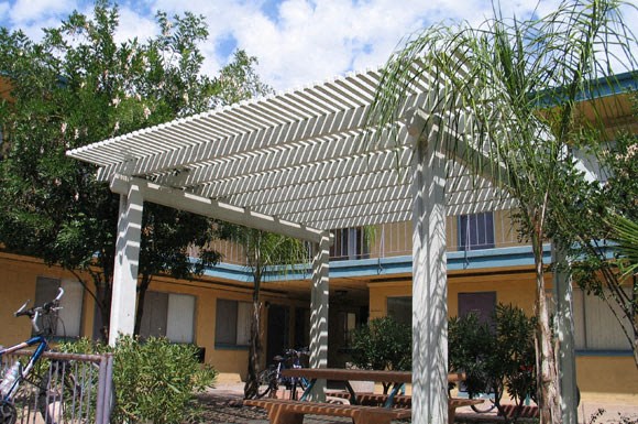 a house with a covered patio and a bike parked in front of it