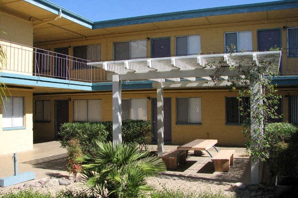 a courtyard with a picnic table and a pergola