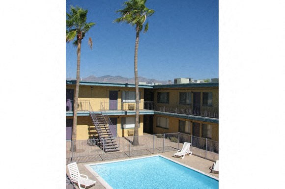 a hotel with a swimming pool and palm trees