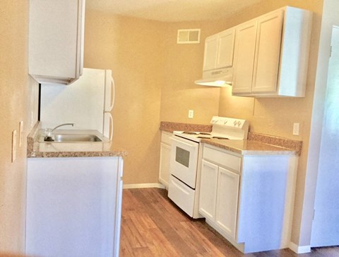 a kitchen with white appliances and white cabinets