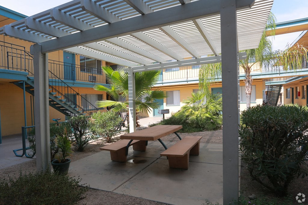 a picnic area with benches in front of a building
