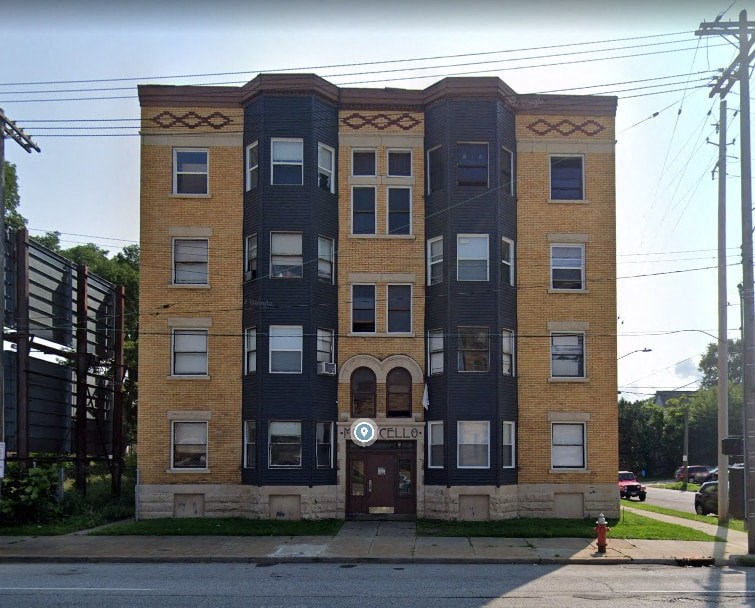 a brick apartment building on the corner of a street