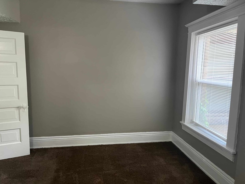 a small room with a window and a door