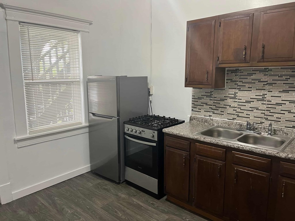 a kitchen with a sink and a refrigerator