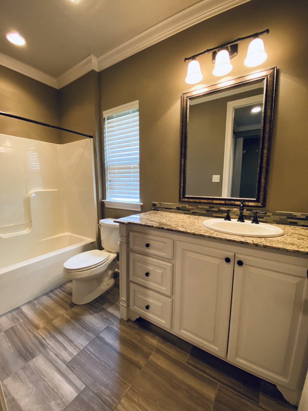 a bathroom with a sink toilet and a shower