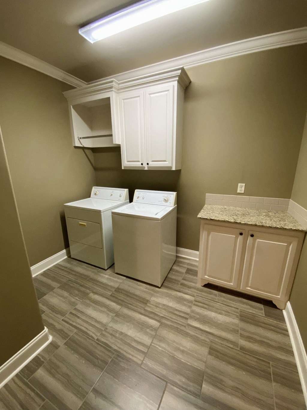 a laundry room with two washer and dryers in it