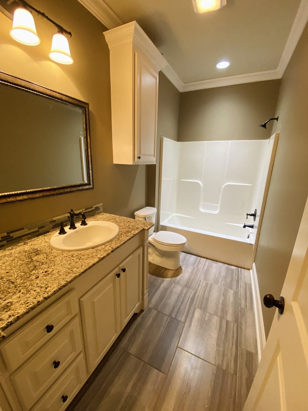 a bathroom with a sink and a toilet and a shower