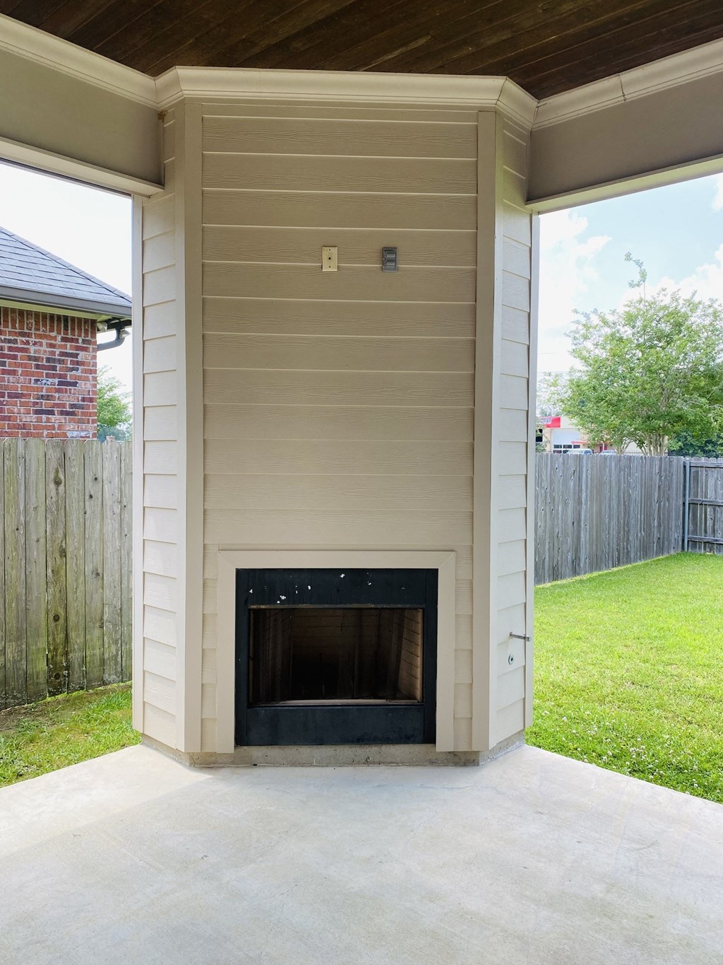 a small fireplace on the side of a house