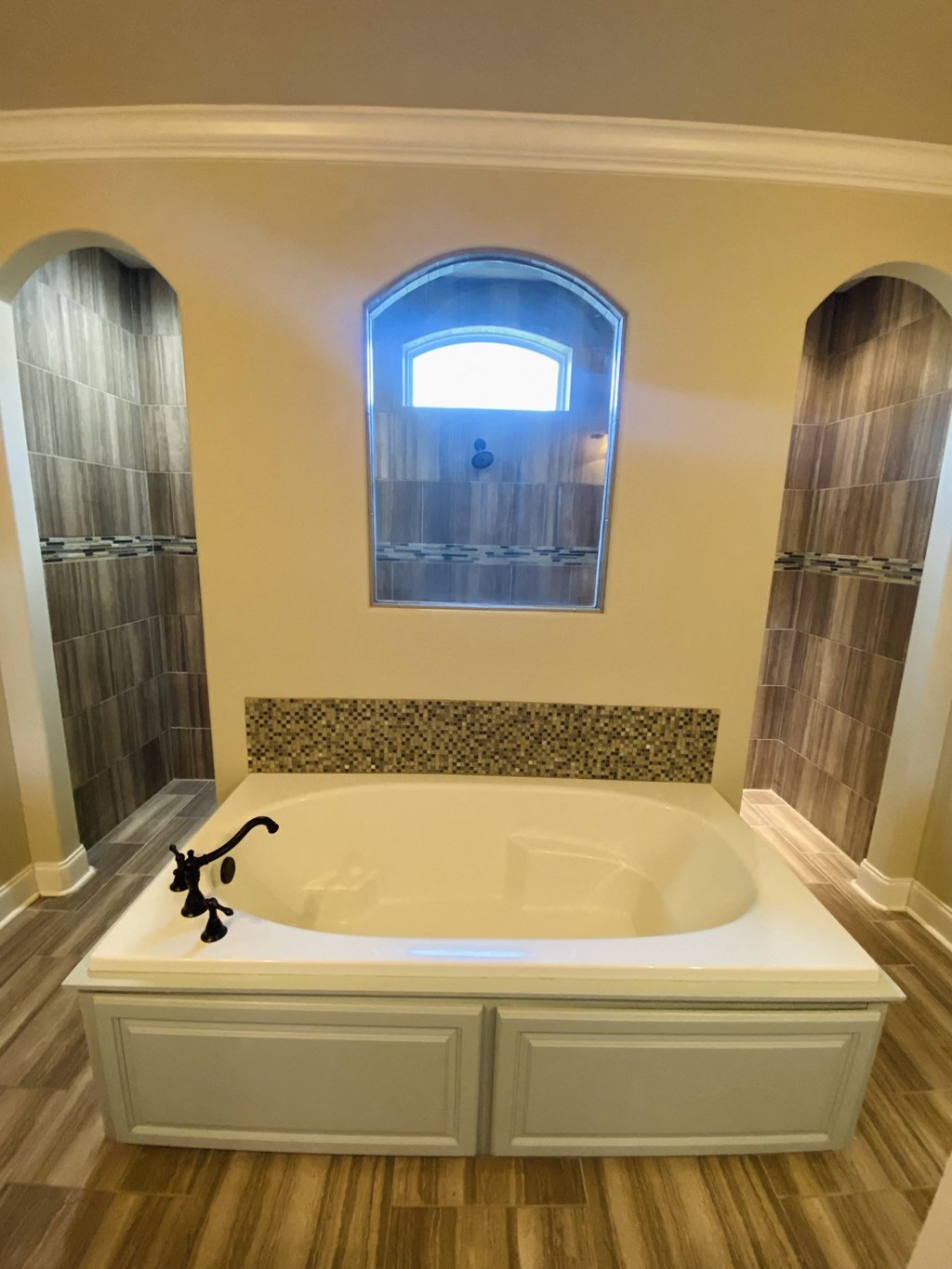 a large bath tub in a bathroom with a window