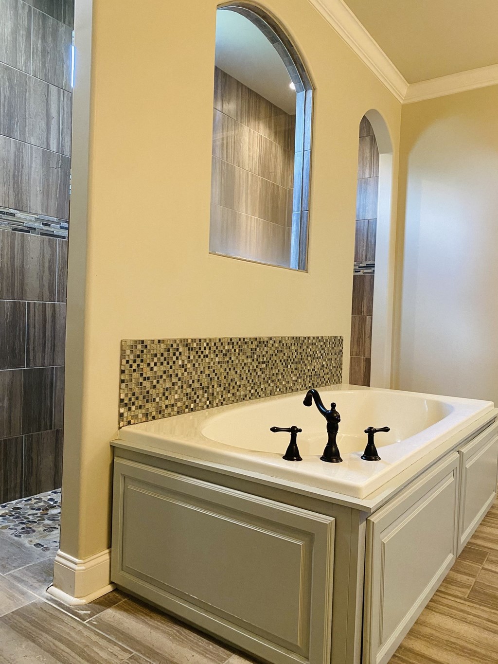 a bathroom with a large tub and a shower