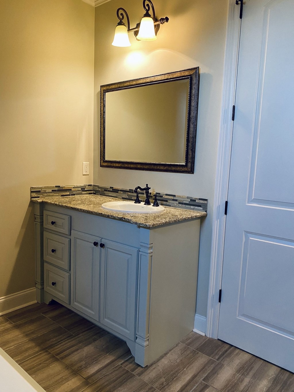 a bathroom with a sink and a mirror
