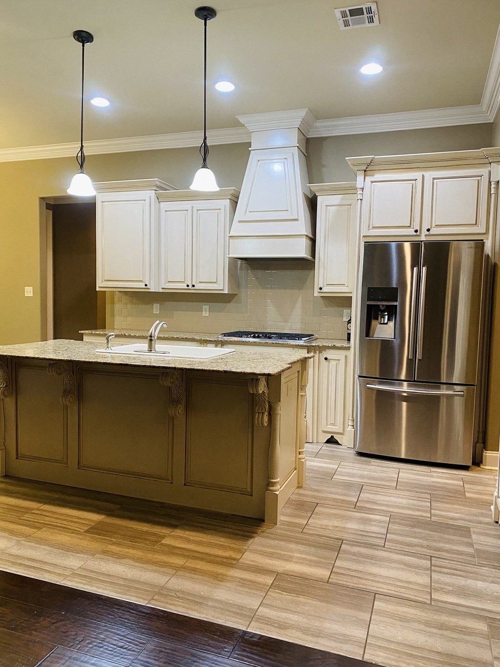 a large kitchen with white cabinets and stainless steel appliances