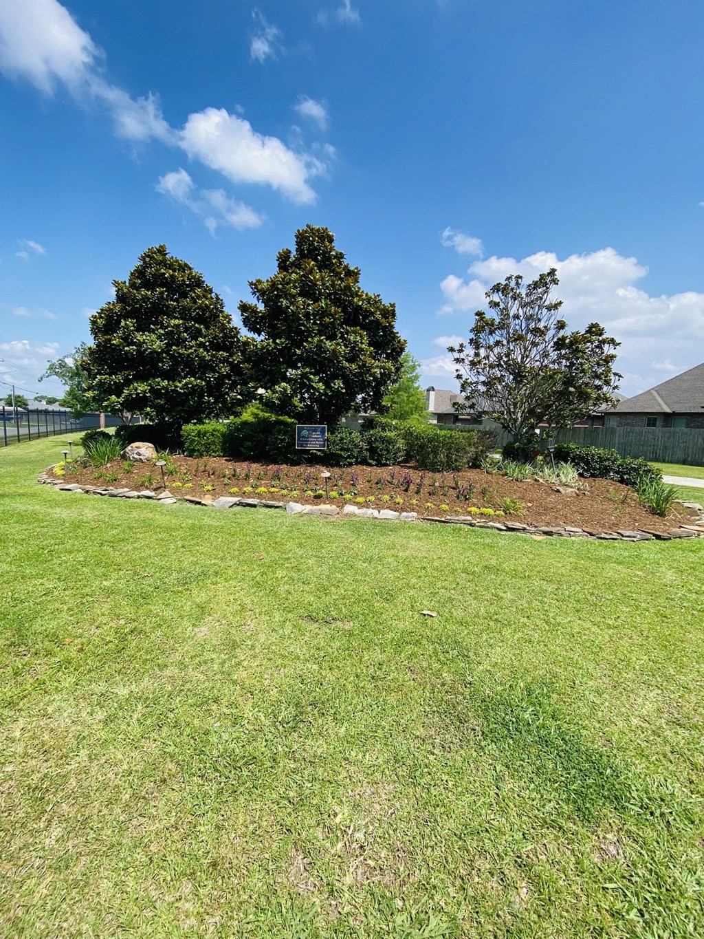 a garden with a mound of dirt and some trees