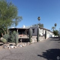 an image of a house with cactus in front of it