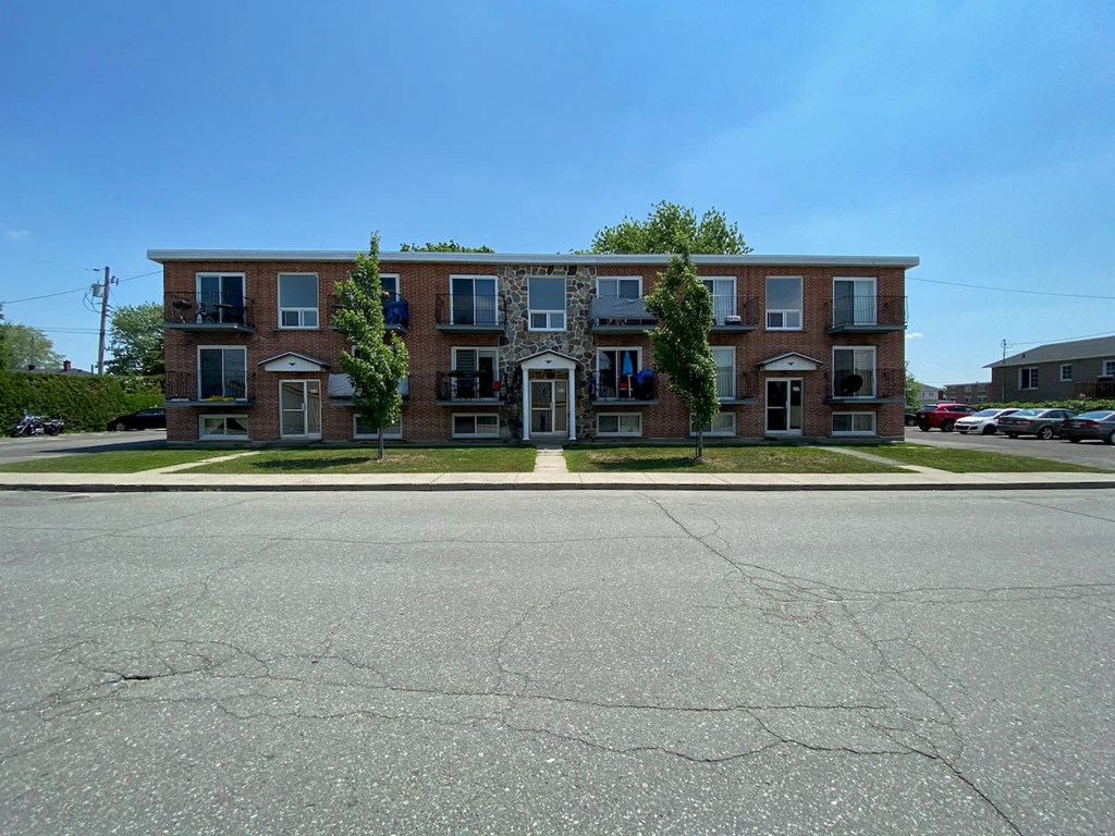an apartment building on the corner of a street