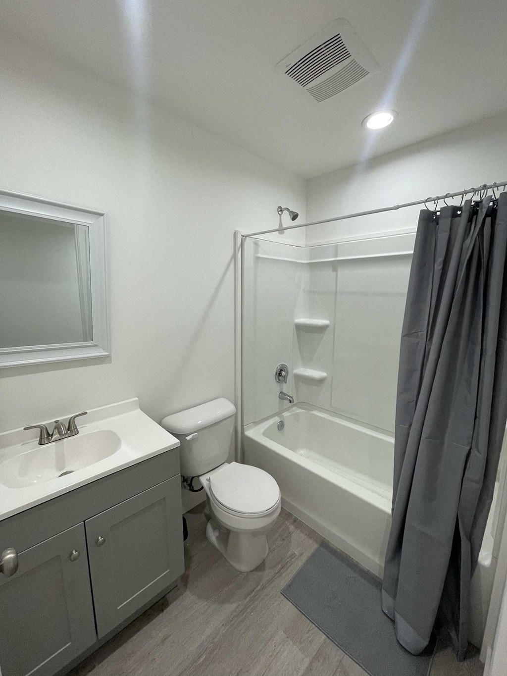 a renovated bathroom with a shower toilet and sink