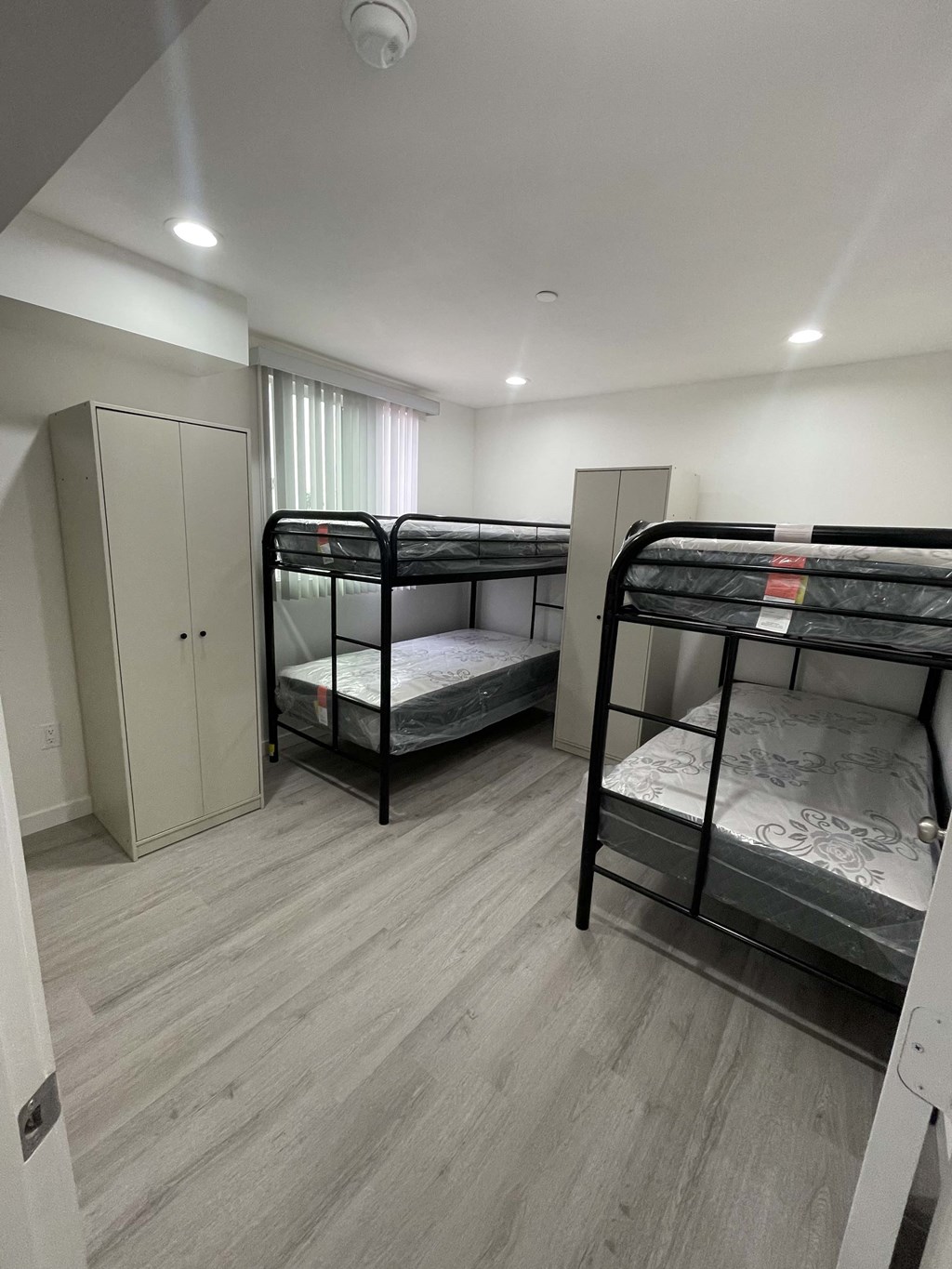 a bedroom with bunk beds in a small room