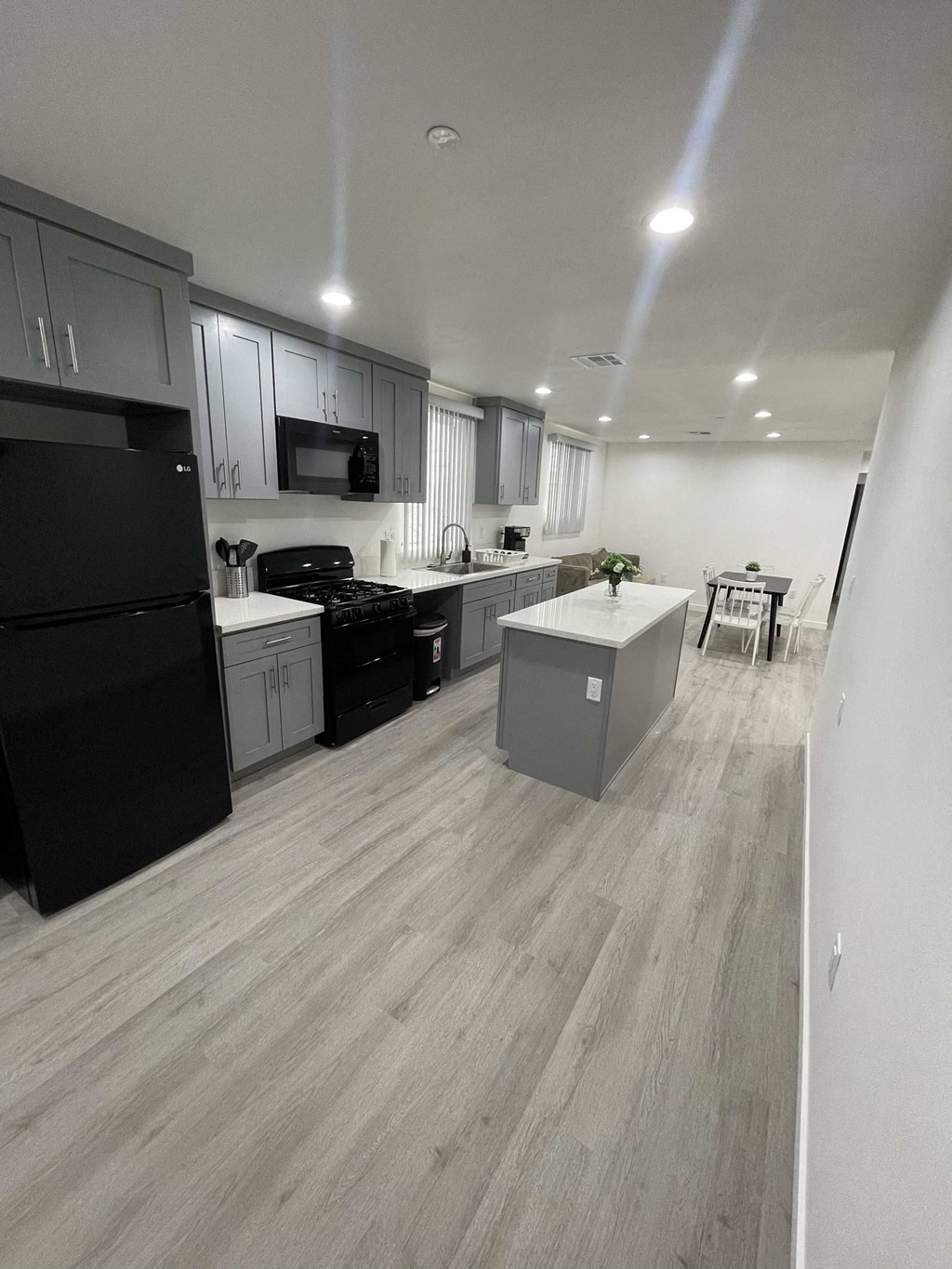 an open kitchen with black appliances and white cabinets