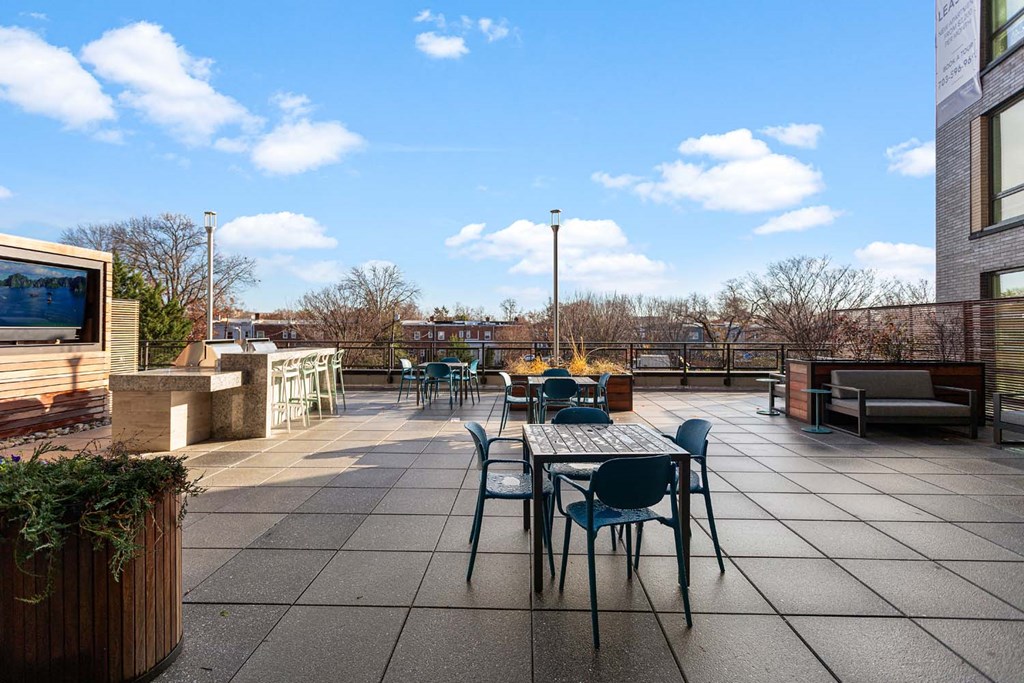 a patio with a table and chairs on it