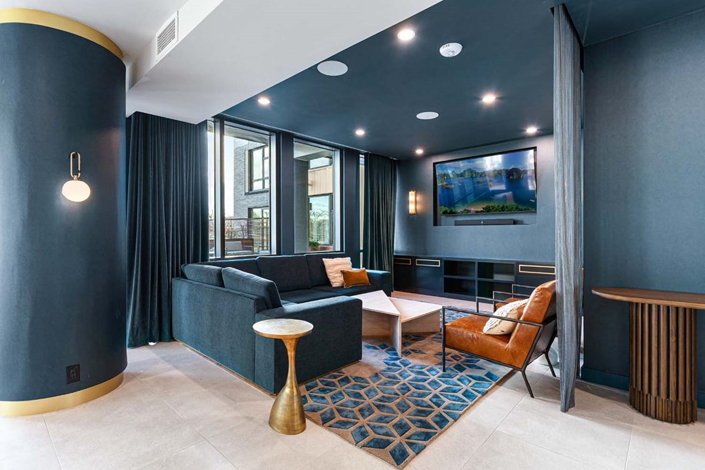 a living room with blue walls and a tv