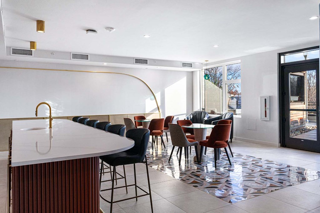 a dining room with a table and chairs and a kitchen