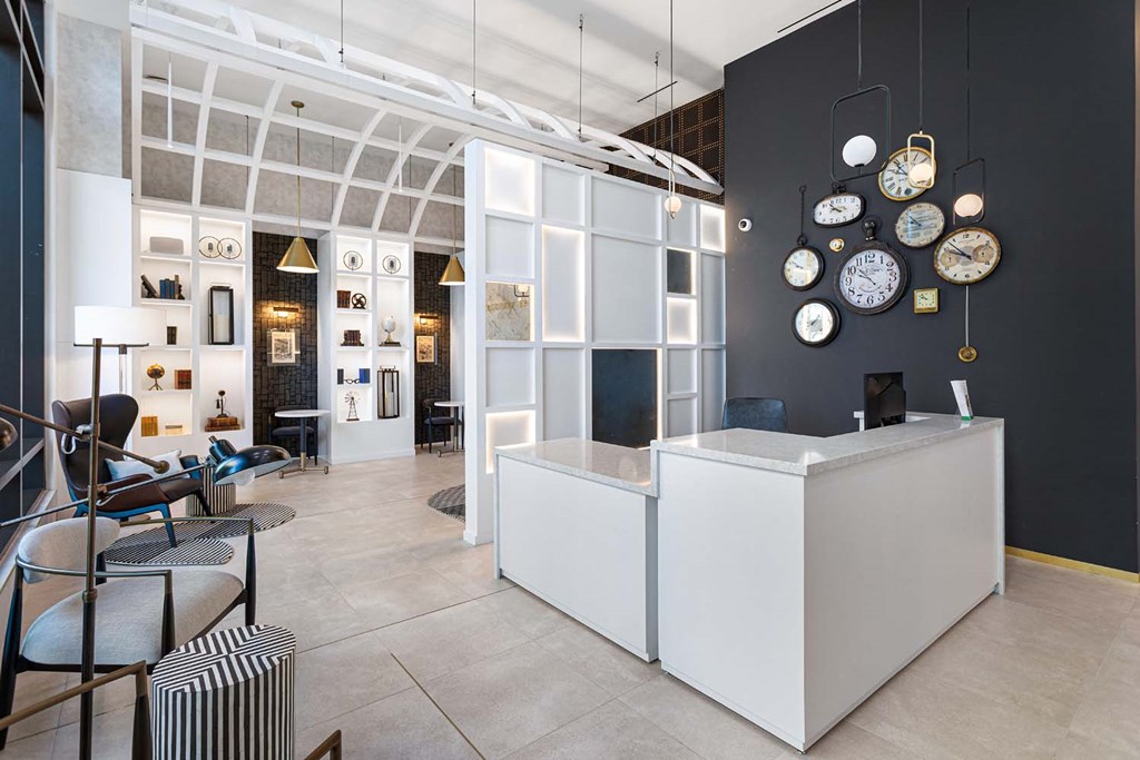 the lobby or reception area of a building with clocks on the wall