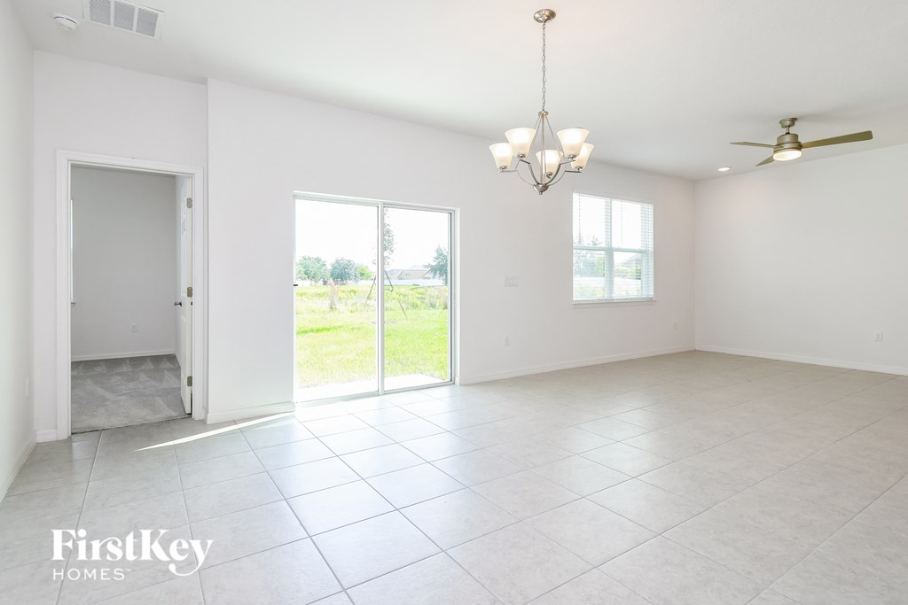 an empty living room with a sliding glass door to the patio