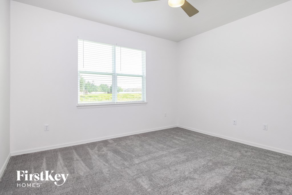 the living room of a home with a carpeted floor and a window