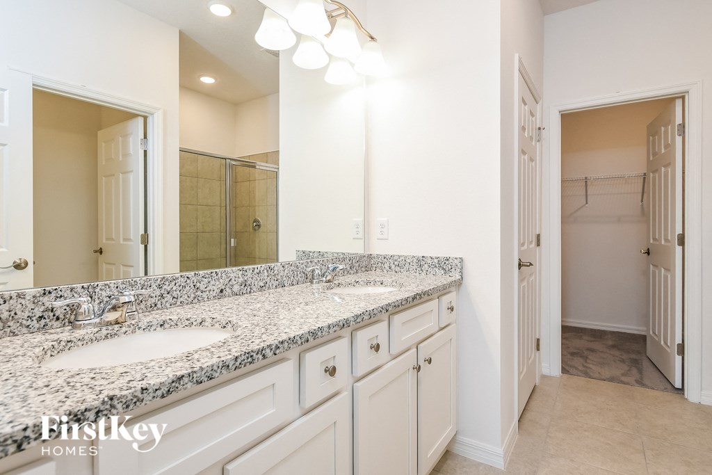 a bathroom with two sinks and a large mirror