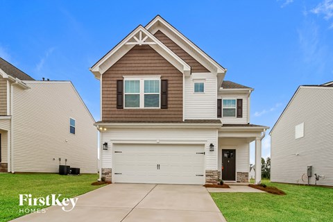 a beige and brown house with a white garage door