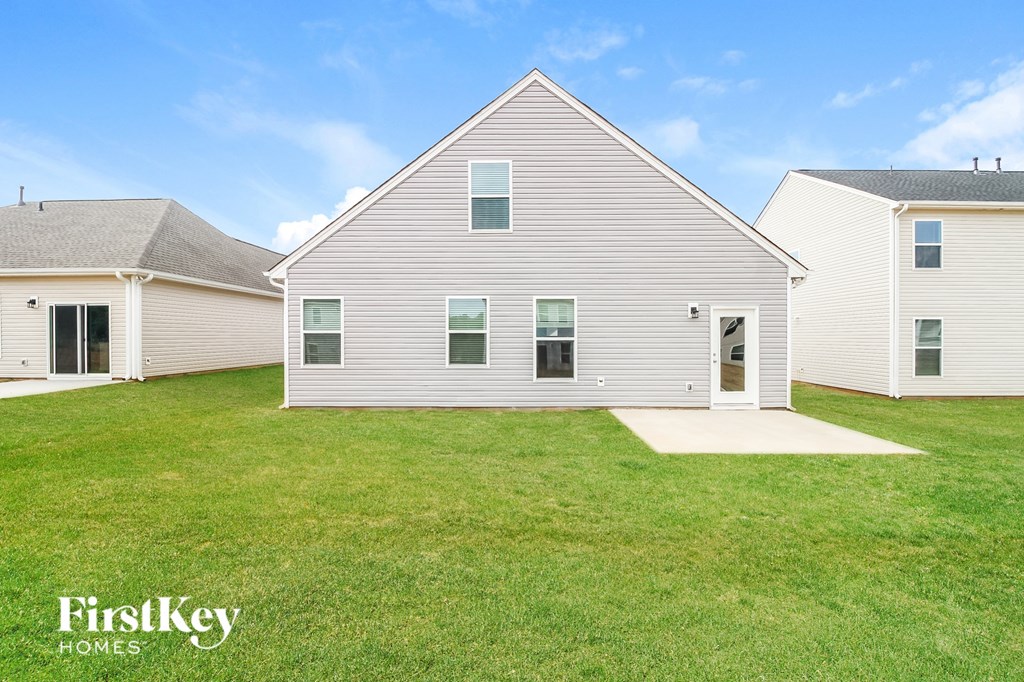 a white house with a yard in front of it