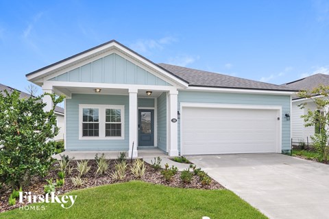 a blue house with a driveway and a garage door