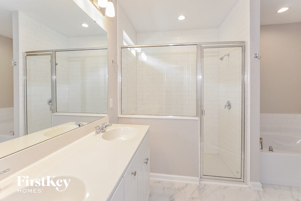 a bathroom with a shower and a sink and a mirror