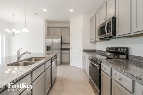 a kitchen with granite counter tops and stainless steel appliances