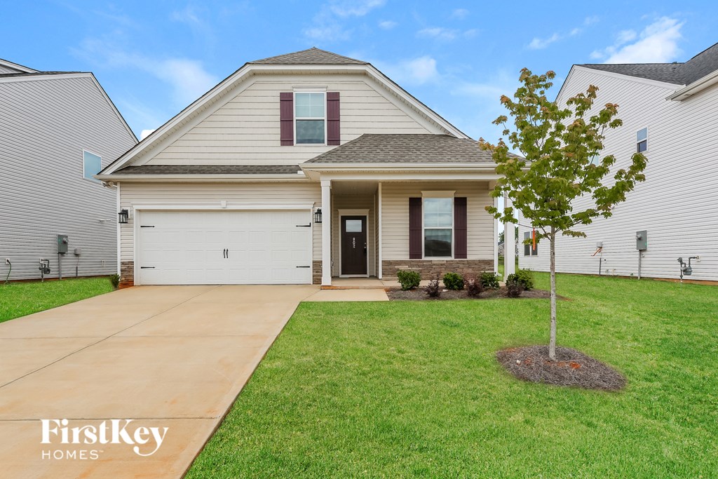 a white house with a yard and a sidewalk