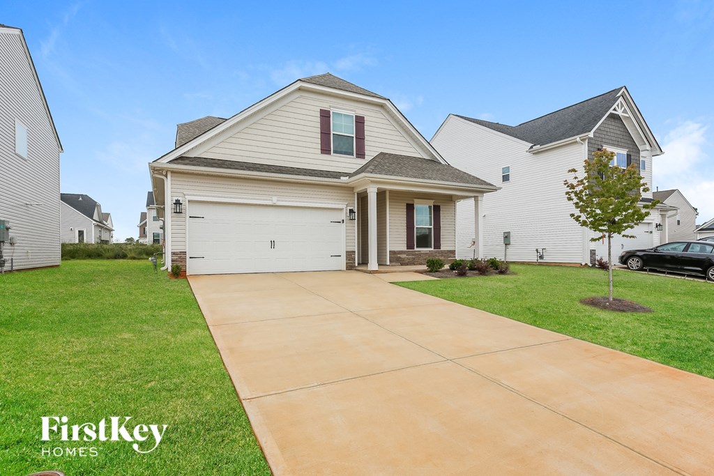 a white house with a driveway in front of it