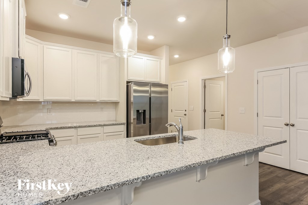 a kitchen with white cabinets and a counter top