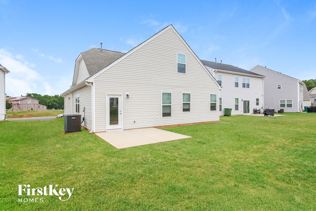 a white house with a yard in front of it