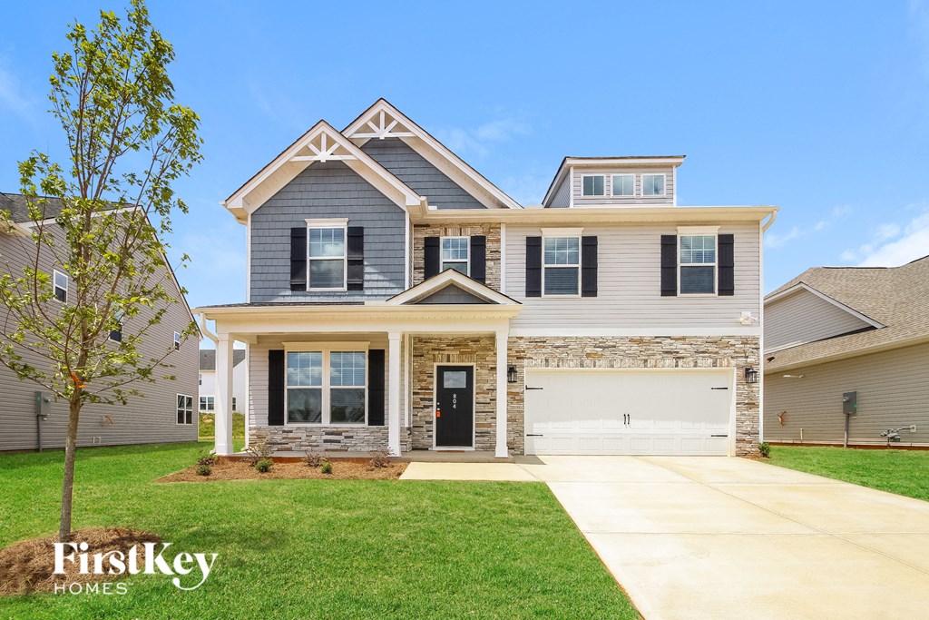 A two-story house with a garage is for sale by FirstKey Homes.